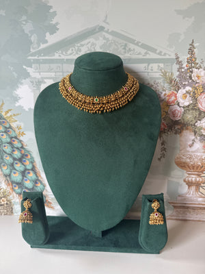 Antique gold temple jhumkas with Lakshmi stud and gold bead fringe