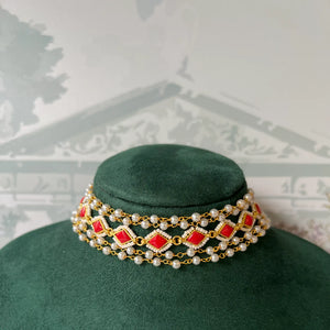 Close-up of multi-strand choker with red stone and pearl beading