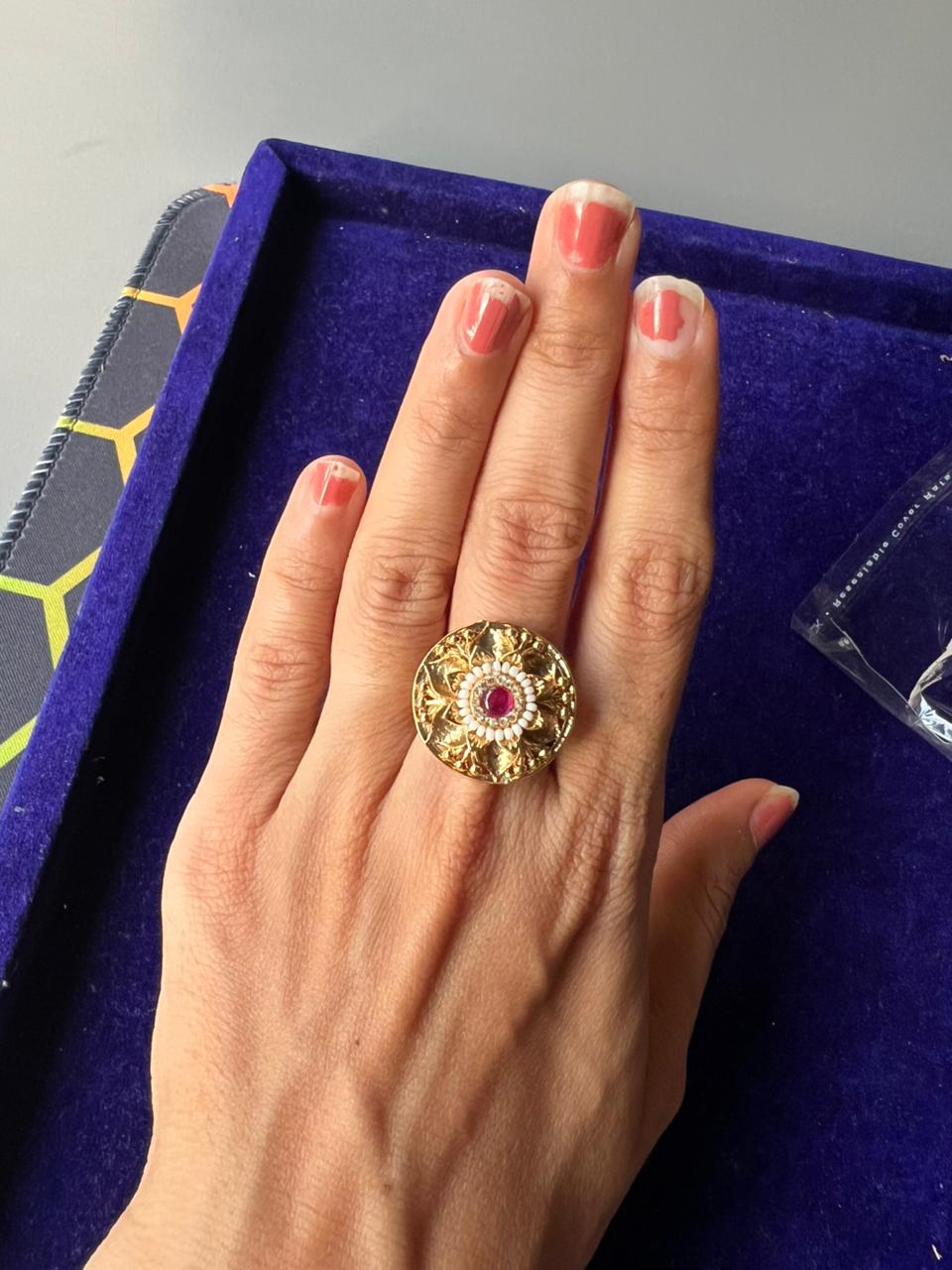 Carved gold dome ring with a pink centre stone and a white seed pearl halo