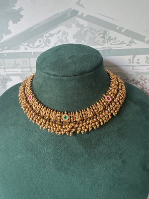 Antique gold Lakshmi temple choker with gold bead fringe and matching jhumkas