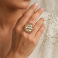 Round gold statement ring with clear kundan stones and a rose-pink baguette border