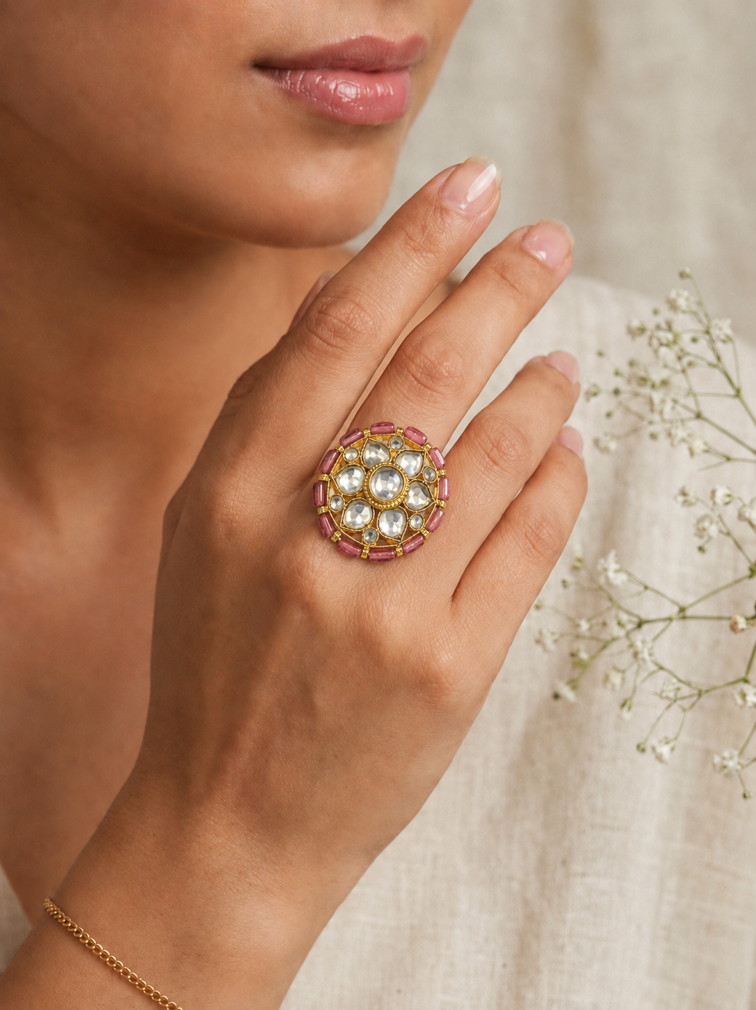 Round gold statement ring with clear kundan stones and a rose-pink baguette border