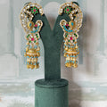 Mother of pearl and firoza peacock ear cuff jhumkas in gold with white kundan and pearl fringe