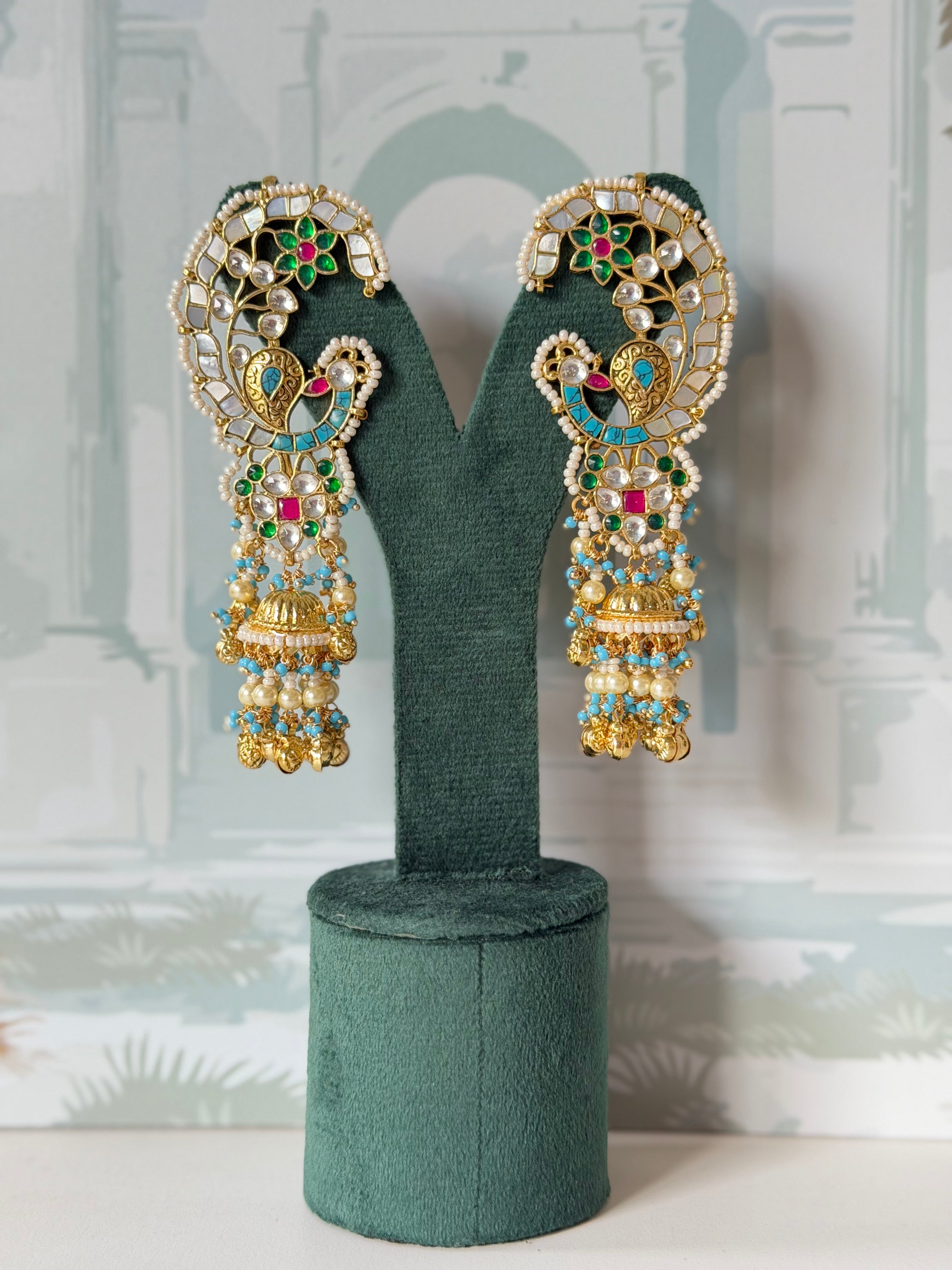 Mother of pearl and firoza peacock ear cuff jhumkas in gold with white kundan and pearl fringe
