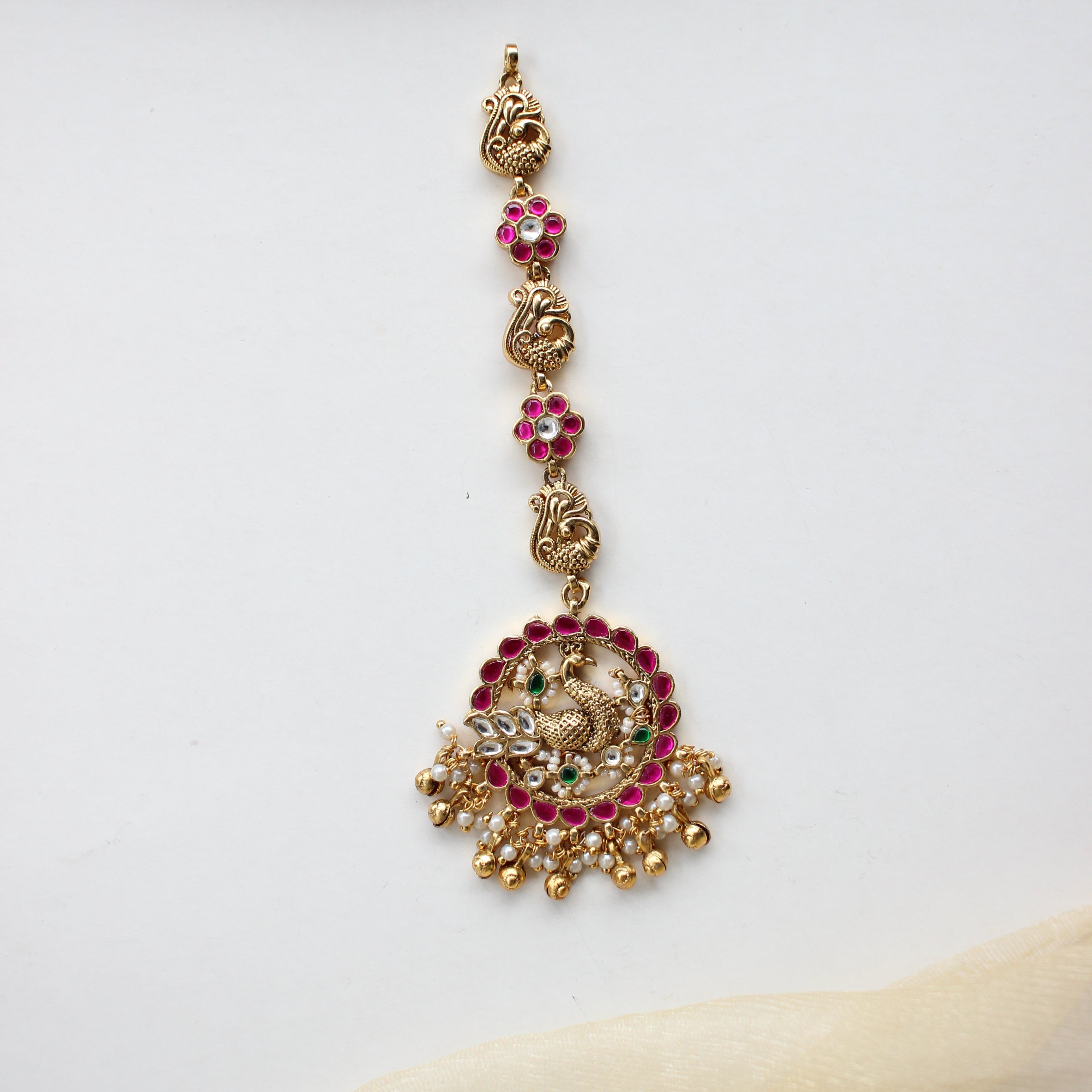 Antique Gold Peacock Maang Tikka – Ruby & Kundan Studded with Floral Charm Drop Chain