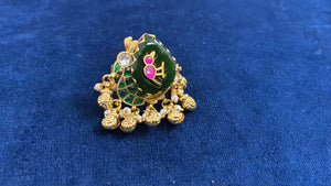 Gold parrot ring on a deep green ambi stone with flat-cut pink jadau work and a seed pearl fringe
