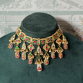 Green and pink jadau choker set with white kundan drops, seed pearls and carved bead fringe